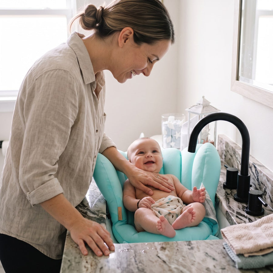 Mum and baby smiling at each other at bath time