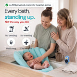 As NHS physios and maternity hospitals advise. Every bath, standing up. Not the way you did. Her daughter bathes her smiling baby in the Sink Bather at the kitchen sink, grandma behind her, the rinser and penguin thermometer on the bench. No bending, no kneeling, held snug, fits her sink.